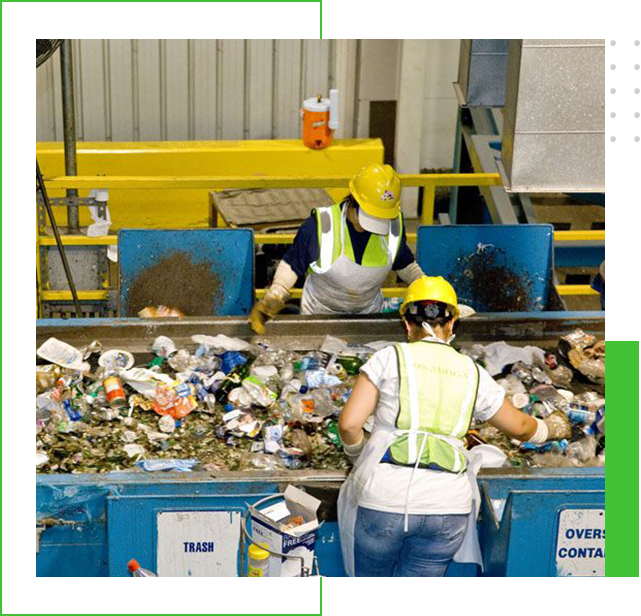 Two people working in a recycling center.